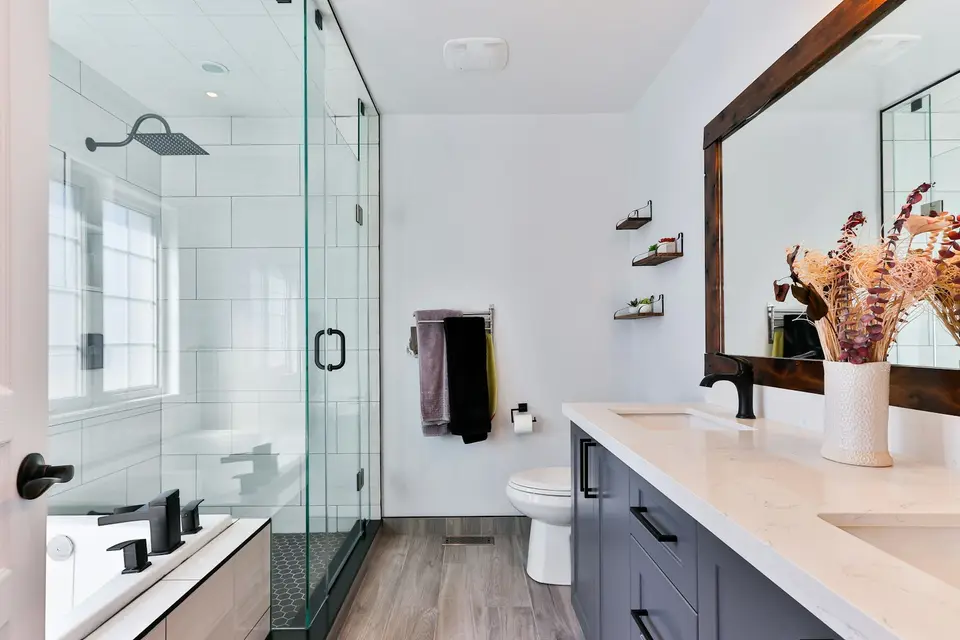 Spotless modern bathroom with glass shower and clean vanity